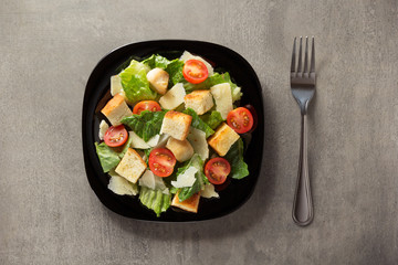 caesar salad in plate at table