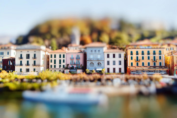Colorful houses in Bellagio on a sunny autumn day, lake Como, Italy. Miniature tilt shift lens effect