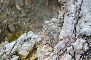 Close-up of a stone in the mountains: colorful rock cliff structure; wild nature