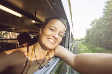 Happy young woman traveling in the train