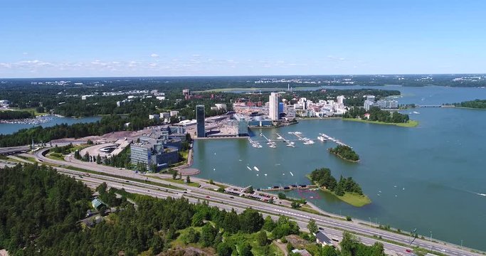 Route 51, Cinema 4k aerial pan view from keilaniemi towards lauttasaari, on road 51 the lansi-vayla, just outside Helsinki, at a sunny day, in Espoo, Uusimaa, Finland