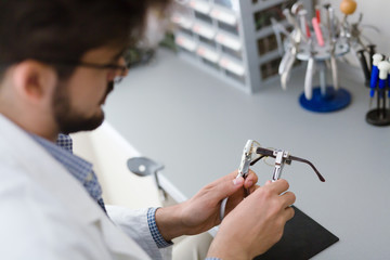 Optician repairing and fixing eye glasses