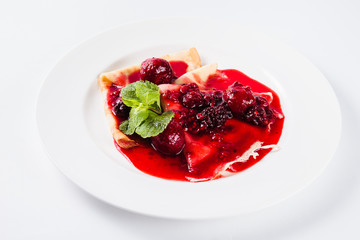 Sweet dessert. Pancakes with berry of the strawberry and raspberry sauce (close)