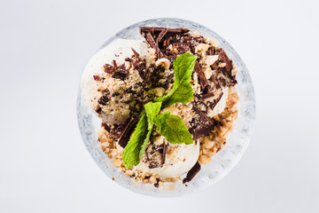 Ice cream in glass bowl on white background (close up)