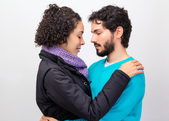 Couple with eyes shut holding each other.