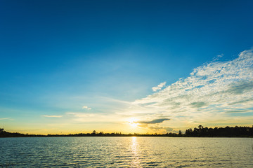 Beautiful sunset landscape with blue sky over lake