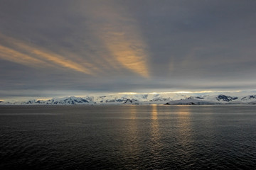 Antarctica landscape, icebergs, mountains and ocean at sunrise, Antarctica
