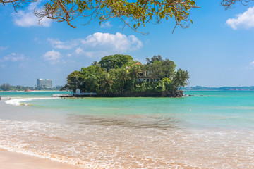 The sandy beach and bay of Weligama with the island Taprobane in the foreground. Originally in Sinhalese called Galduwa, means Rock Island. The beach in the south  is very popular among surfer