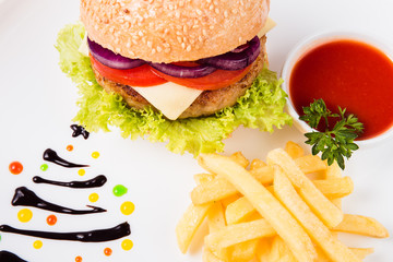 burger sauce and french fries on a  round  white plate