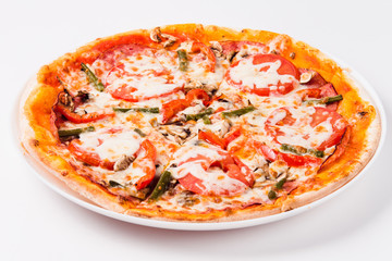 Pizza with tomato, mushrooms, bell peppers on a white plate on a light background
