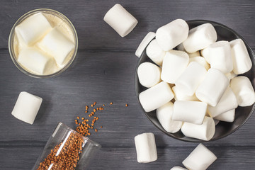 Coffee  with marshmallows on black wood table