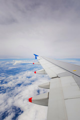 Fototapeta na wymiar Flying airplane above clouds
