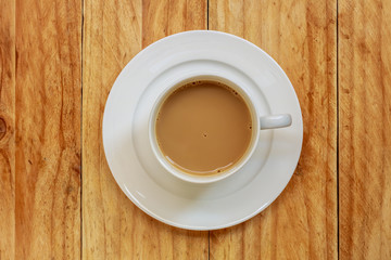 Coffee cup on wooden table, Top view.