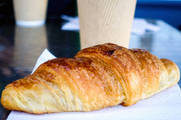 Breakfast with coffee and croissants on table