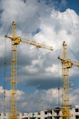 Tower crane on a background of clouds