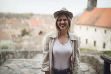 Happy blond female wearing hat outdoor