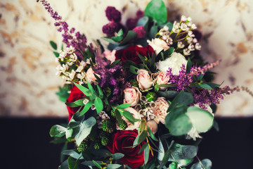 Beautiful wedding bouquet in the hands of the bride