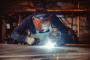 Man with safety glasses welding