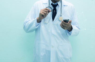 Medical doctor in white gown stand working with his smart phone