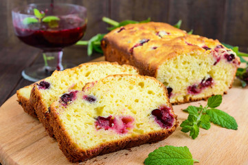 Delicate tasty curd cake with black currant and jam on a dark wooden background.