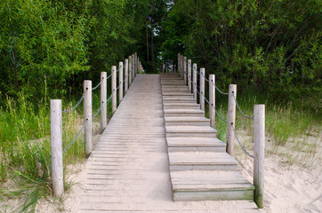Fototapeta premium Wooden Beach Sidewalk leading into Forest in Jurmala, Latvia