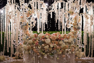 Fresh flowers in a wedding decoration. Night Banquet