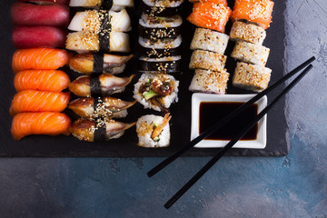 Japanese sushi big set with two wooden black chopsticks, top view
