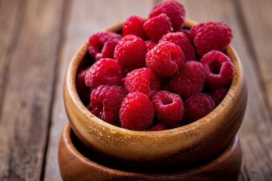 Berry Fresh in a wooden bowl on a vintage background. Raspberry.Food or Healthy diet concept.Super Food.Vegetarian.selective focus.