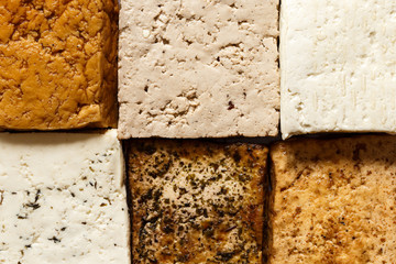 Background of different klinds of tofu blocks from above. - obrazy, fototapety, plakaty