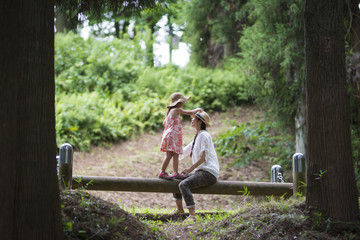 Mother and daughter playing in the forest