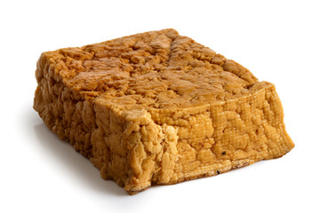 Single block of smoked tofu isolated on white.
