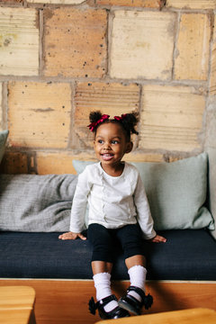 Natural light portrait of a 2 year old girl with pig tails