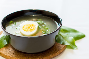 A fresh green soup with spinach sorrel egg potato