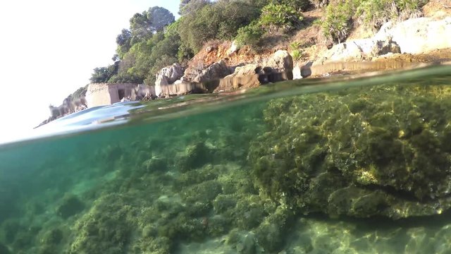 Split underwater view of Alghero shoreline. Sardinia, Italy