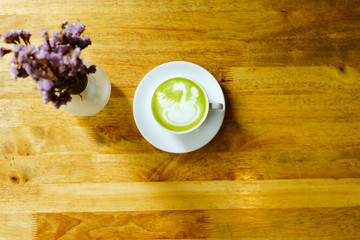 matcha latte on a wooden background in coffee shop
