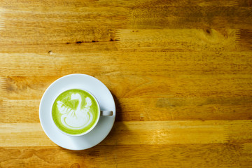 matcha latte on a wooden background in coffee shop