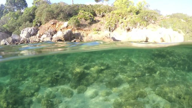 Split underwater view of Alghero shoreline. Sardinia, Italy