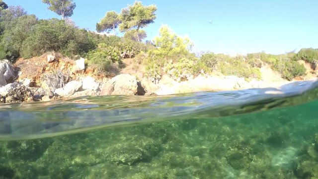 Split underwater view of Alghero shoreline. Sardinia, Italy