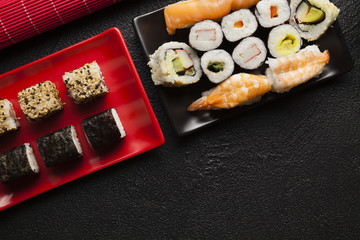 Sushi set on black table background