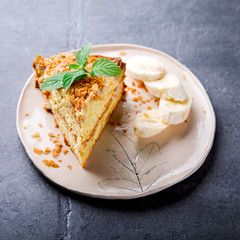 Pie with bananas, chocolate icing and fresh mint.Baking on the gray background.Copy space for Text. selective focus.