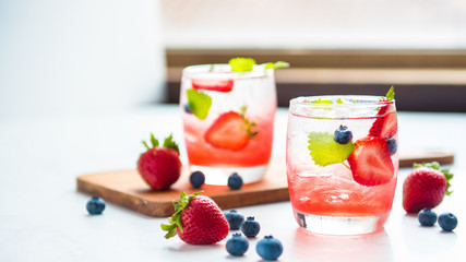 set cocktails strawberry and blueberry mix soda for healty drink but mix whisky for party enjoy