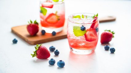 set cocktails strawberry and blueberry mix soda for healty drink but mix whisky for party enjoy