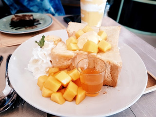 Ice cream and mango on bread topped with caramel.