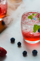 set cocktails strawberry and blueberry mix soda for healty drink but mix whisky for party enjoy