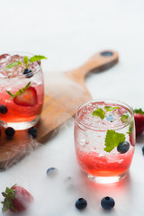 set cocktails strawberry and blueberry mix soda for healty drink but mix whisky for party enjoy