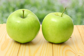 Green apple on wooden table