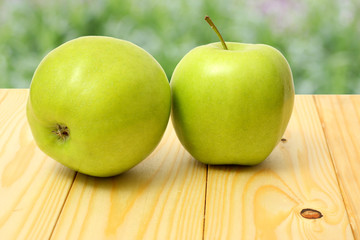 Green apple on wooden table