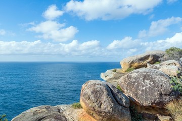 The Gap - ocean cliff at Watsons Bay on blue sky with clouds, Sydney