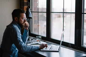 Young man designer working from home apartment office