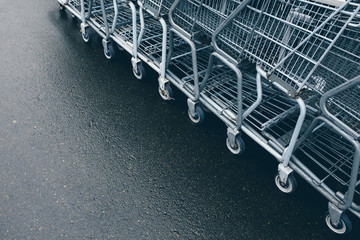 Row of metal grocery carts outside store